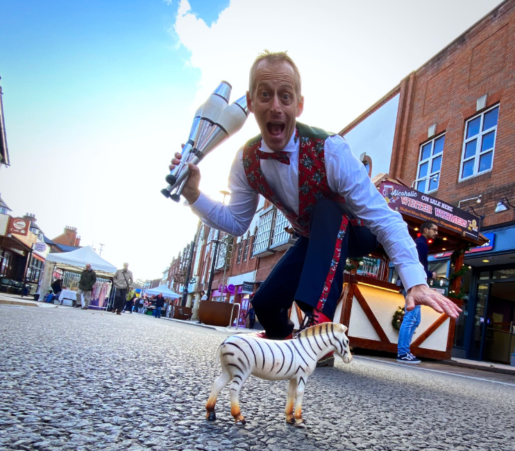 Zebra Crossing Brett Sirrell Juggler and street entertainers at a christmas lights turn in council style public event entertainment with a zebra crossing in a town in the midlands near Birmingham