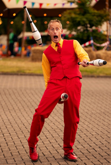 comedy performer Brett at circus themed party juggling