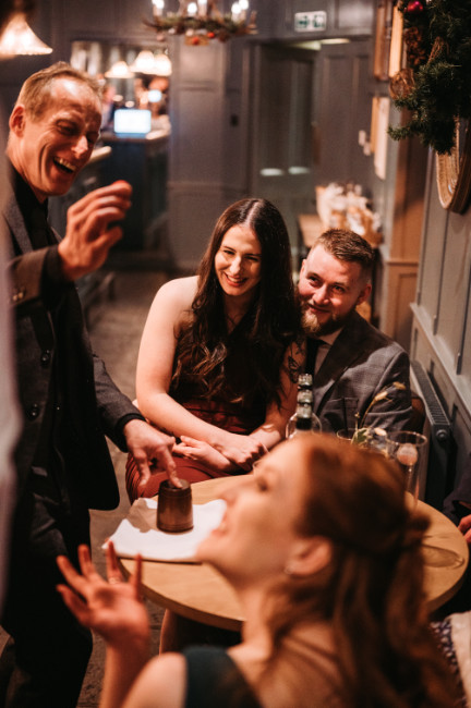cup ball trick Brett performing Magic circle style magic at a party as guest laugh and are entertained